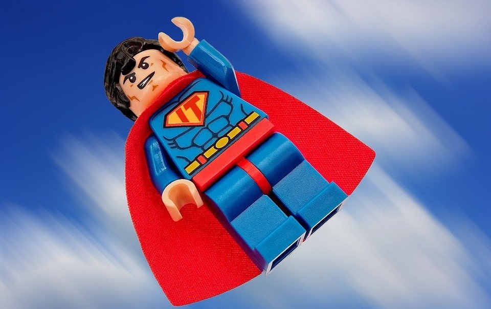 Be an Action Hero: Lego Superman flying through the air.