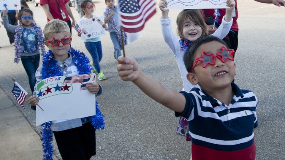 What are your priorities for the 2020 primary? - Photo with kids in patriotic dress marching in parade.